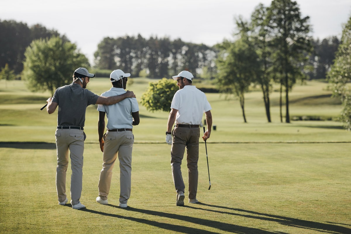 3 golfers with their backs to camera enjoying a round of golf without golfers elbow injury